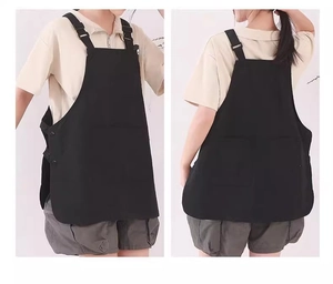Front and back view of a black waterproof work apron with shoulder straps and side buttons