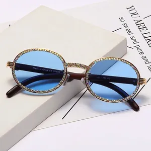Chic round sunglasses with blue lenses and crystal-embellished frame for a luxury vintage look