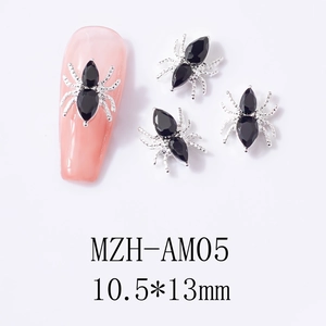 Macro shot of silver spider nail charms with black rhinestones on pink nails, 10.5x13mm