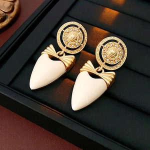 Vintage bow heart stud earrings with gold metal finish and creamy glaze heart drops