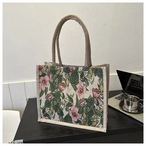 Close-up of retro floral jacquard tote bag showing woven texture and sturdy handles