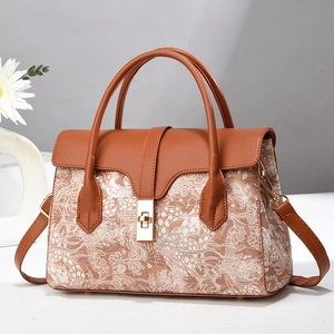 Elegant brown leather bucket handbag with beige floral patterns and gold metal buckle