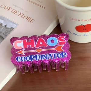 Purple glitter hair claw clip with Chaos Coordinator text and heart arrow pattern