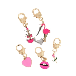Five pink enamel charms with gold lobster clasps including heart and flamingo designs
