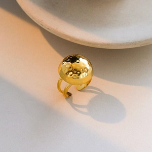 Detail of gold-plated ring showing round hammered texture and double-layered open band