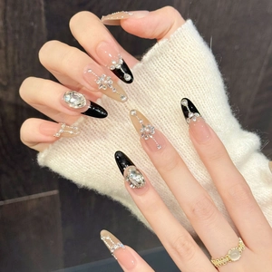 Luxury long almond press-on nails with black French tips, rhinestones, and pearls