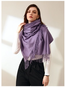 Detail of purple faux cashmere scarf with soft tassels draped over model's shoulders
