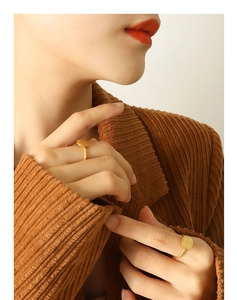 Detail view of a 18k gold-plated titanium ring with an embossed Chinese Fu character