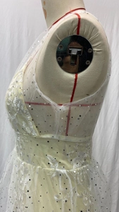 Close-up of sleeveless V-neck wedding dress featuring lace embroidery and silver sequins
