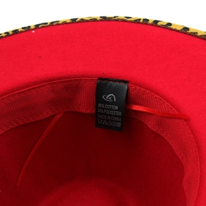Detail of red fedora hat interior showing 65% cotton blend label and leopard print brim