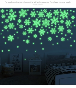 Glow-in-the-dark green snowflake wall stickers showing luminous effect in a dark bedroom
