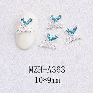 Detail of lake blue rhinestone heart nail charm with silver Love engraving 10x9mm