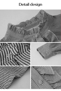 Détails du col montant à volants et boutons en tissu sur le chemisier rayé noir et blanc