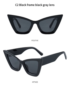 Detail of vintage cat-eye sunglasses featuring black frame and dark gray lenses