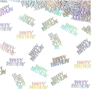 Macro detail of iridescent silver Happy Birthday metallic table confetti for parties