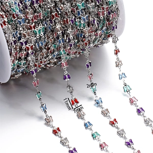 Macro detail of multi-color enamel butterfly chain showing 11x7mm size for DIY jewelry