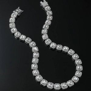 Close-up of hip-hop silver square zircon necklace with sparkling crystals on black surface