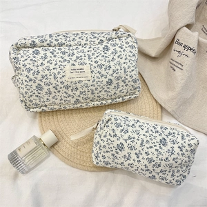 Detail of floral quilted cotton makeup bags in large and small sizes with zippers