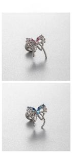 Detailed view of silver bow earrings with pink and blue gradient zircon stones