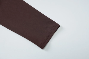 Detailed view of long sleeve cuffs on a slim fit dark coffee summer dress with neat stitching