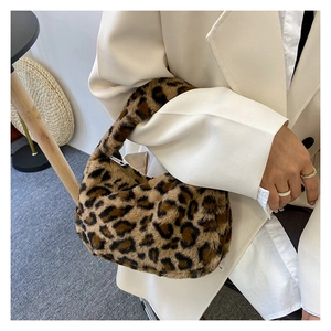 Detail shot of plush faux fur leopard print handbag texture and pattern for women