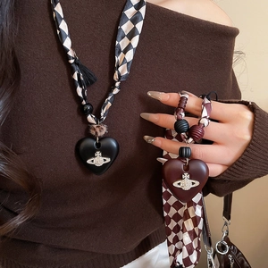 Detail of heart pendant necklace with vintage wood beads and crystal orb logo