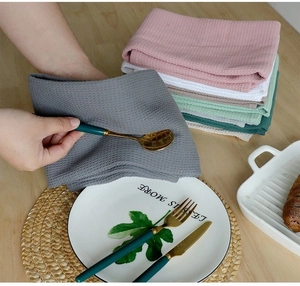 Detailed waffle weave texture on soft gray cotton kitchen towels for home decor