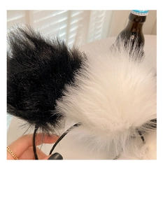 Close-up of fluffy plush cat ear headband showing soft faux fur texture and detail