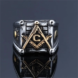 Macro detail of retro stainless steel Masonic ring with gold G symbol and compass design