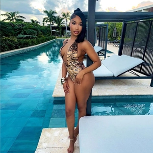Detailed view of sexy halter tiger print swimsuit with deep V-neck and side cutouts