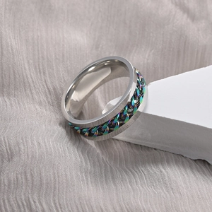 Macro view of men's spinner ring with rotatable rainbow plated Cuban chain detail