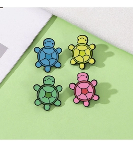 Set of four colorful cartoon turtle enamel pins in blue, yellow, green and pink colors