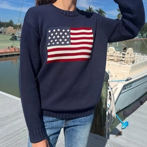 Detailed knit texture of navy blue round-neck sweater featuring USA flag jacquard pattern