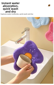 Macro shot of absorbent coral fleece flower towel drying a ceramic cup in a clean kitchen