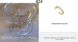 Detailed view of adjustable gold-plated ring with shimmering zircon and pearl inlay