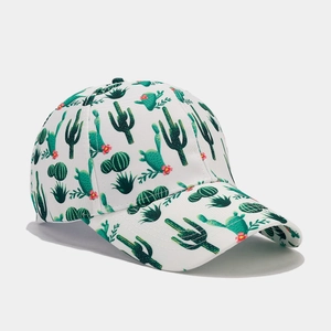 Detailed close-up of tropical cactus and floral print on white canvas baseball cap