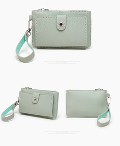Detailed view of mint green pebble leather coin purse with front flap and wrist strap