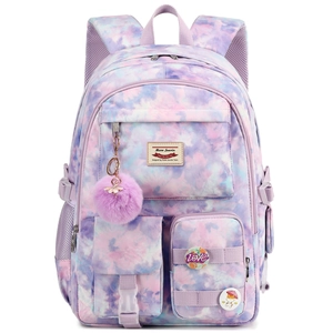 Detail view of tie-dye backpack with plush ball charm and decorative badges