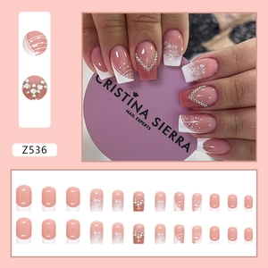 French style press-on nails set in nude pink with glitter and rhinestone accents