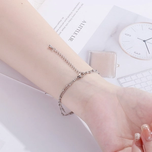 Close-up of double-layer stainless steel bead chain bracelet on wrist with lobster clasp