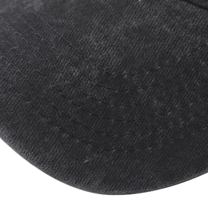 Close-up detail of reinforced parallel stitching on a black washed cotton baseball cap brim