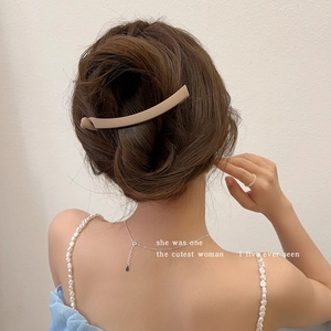 Matte khaki banana hair clip shown on model for back-of-head ponytail styling