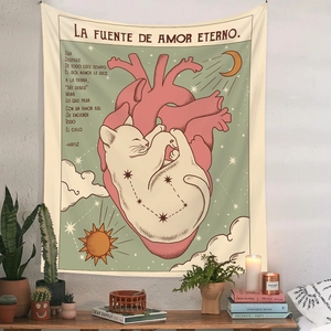 Detail of a cat sleeping on an anatomical heart tapestry with moon and sun motifs