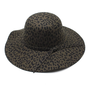 Olive green leopard print wide brim fedora hat with decorative ribbon on white background