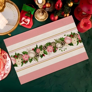 Detailed view of Christmas placemat with festive pine cones and red poinsettia print