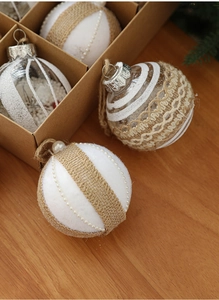 Detail of assorted 8cm white and burlap Christmas tree balls in a rustic gift box