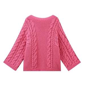 Detailed view of chunky cable knit texture on magenta crew neck sweater