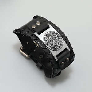 Close-up of black leather Viking bracelet with Vegvisir compass metal plate and belt buckle