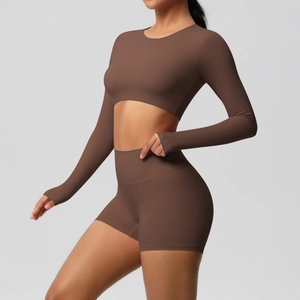 Detailed side view of dark chocolate two-piece yoga set with long sleeve top and high waist shorts