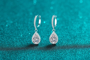 Close-up of elegant S925 silver teardrop earrings with sparkling moissanite stones